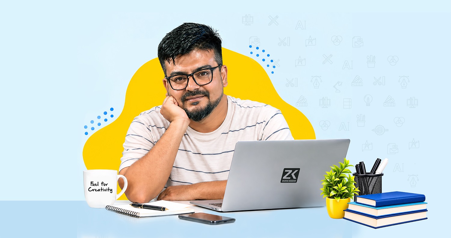ZK, graphic designer, sitting at his desk with a laptop